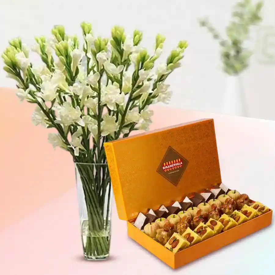 Golden Star Mix Mithai from Bikanerwala with Rajnigandha Stems in Glass Vase