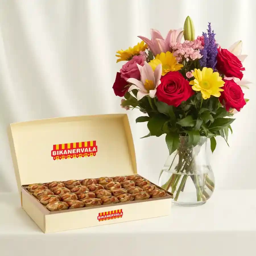 Bikanervala Pinni Special with a Mixed Flower Arrangement