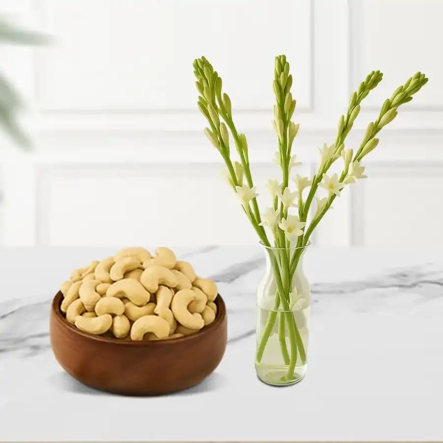Kaju King from Shree Mithai with a Rajnigandha Stems in a Glass Vase