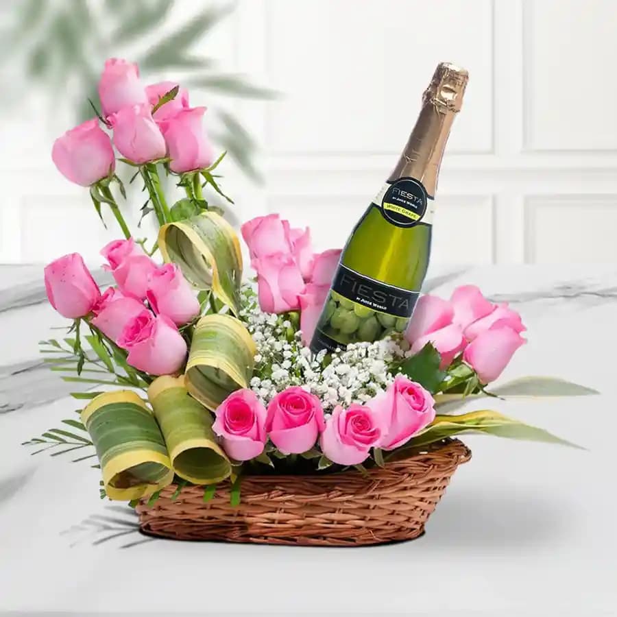 Exotic Arrangement of Pink Roses along with a Bottle of Sparkling Fruit Juice