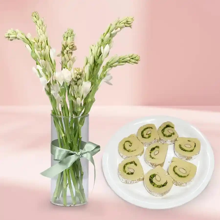 Kaju Cake from Mithas Delicious Sweets with Rajanigandha Stems in Glass Vase