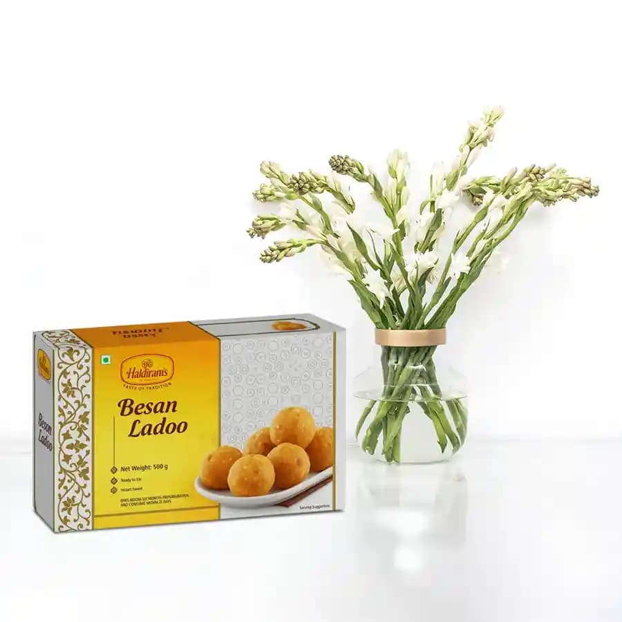 Besan Ladoo with Rajanigandha Stems in a Glass Vase