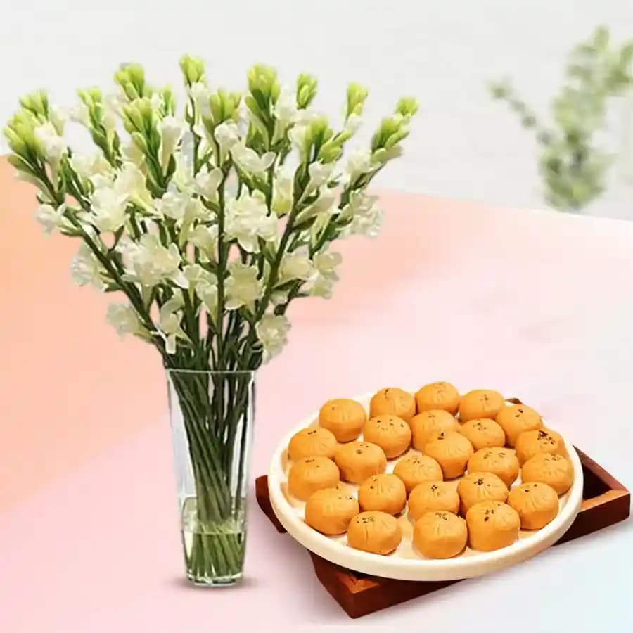 Mathura Peda with Rajnigandha Stems in a Glass Vase