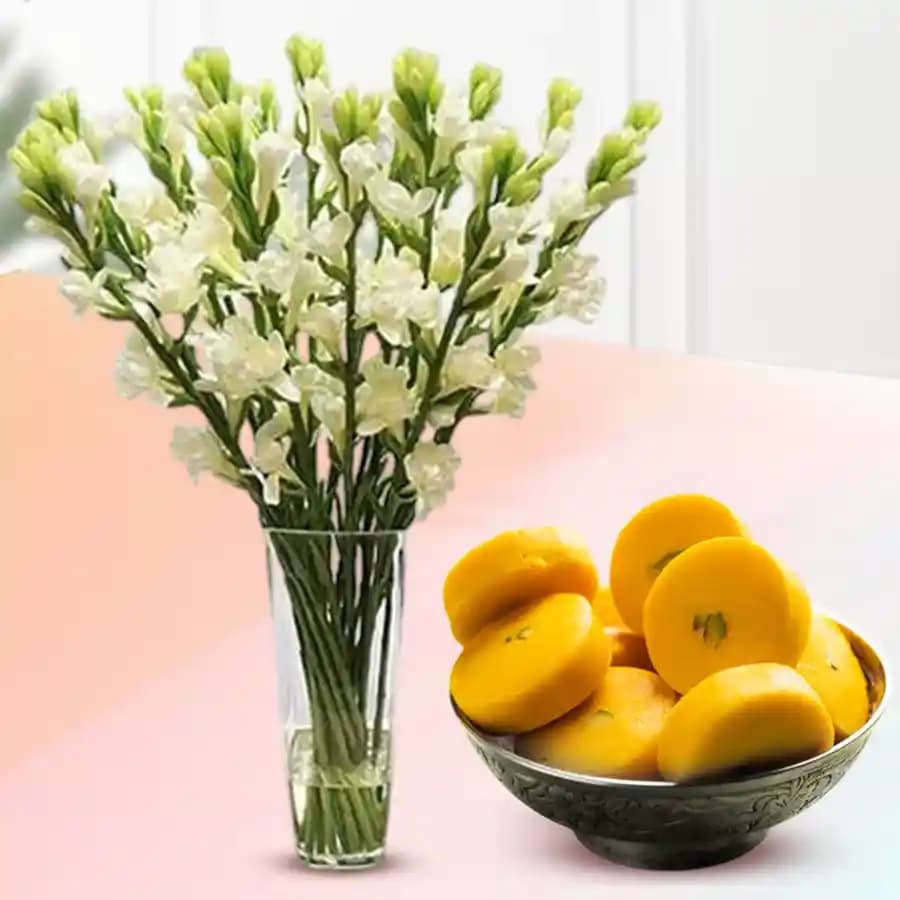 Kesar Peda from Sri Krishna Sweets with a Rajnigandha Stems in a Glass Vase
